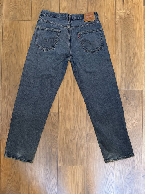 Vintage Levi's 550 jeans in distressed mid wash — back